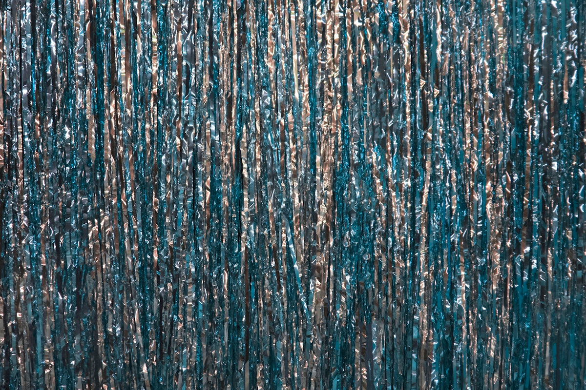a blue curtain with silver foil on it