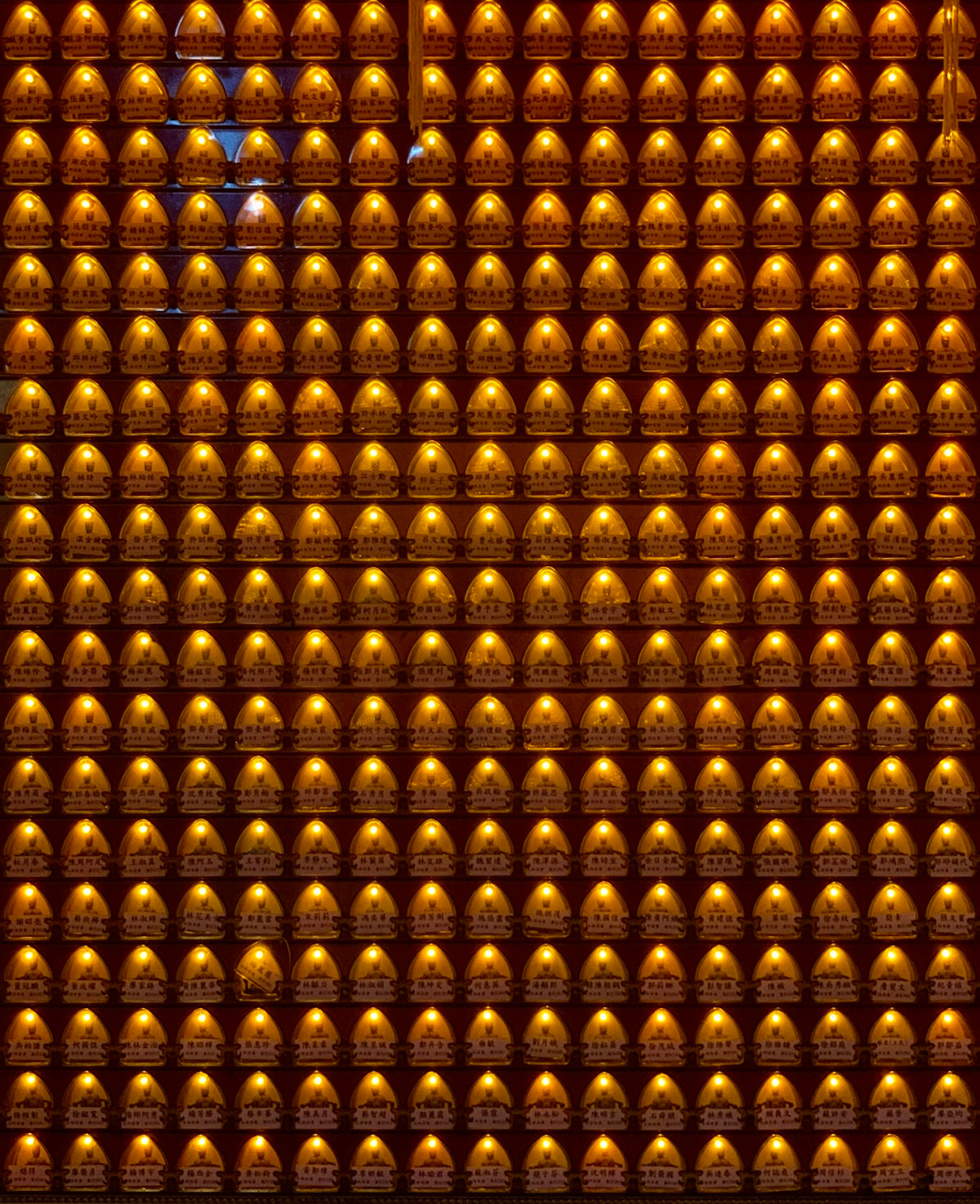 a wall of gold bells in a building