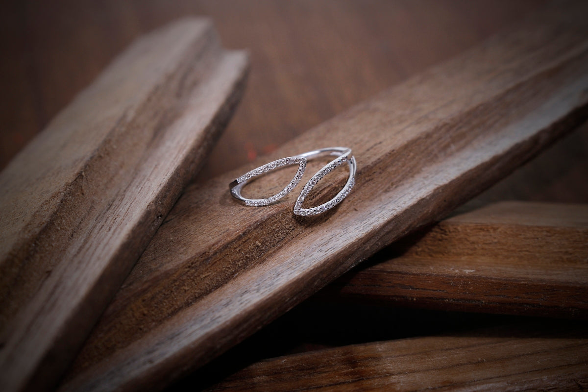 silver ring on brown wooden surface