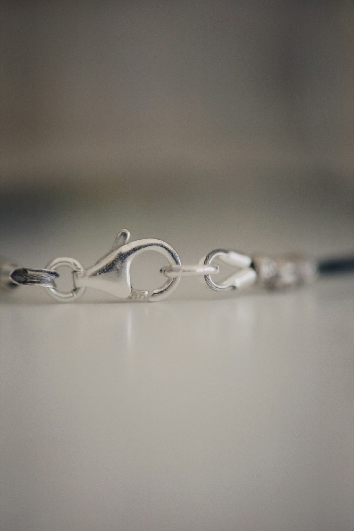 a close up of a silver bracelet on a table