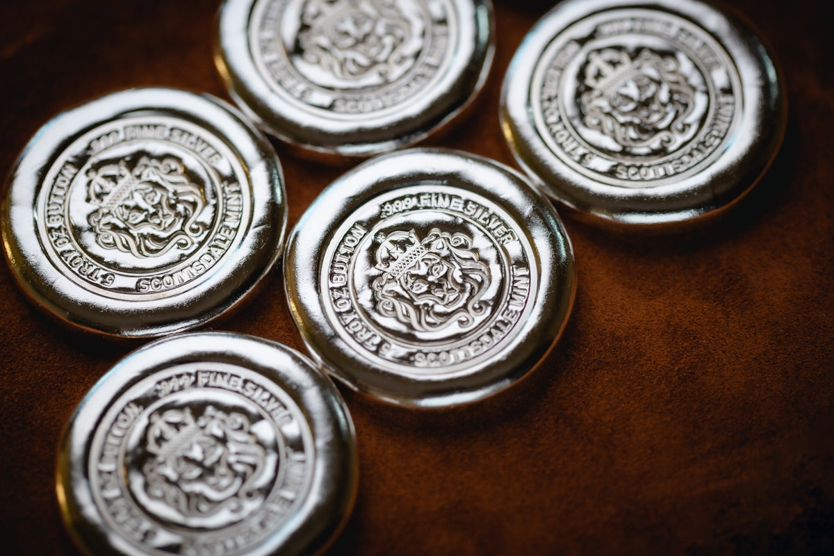 a group of four metal buttons sitting on top of a table