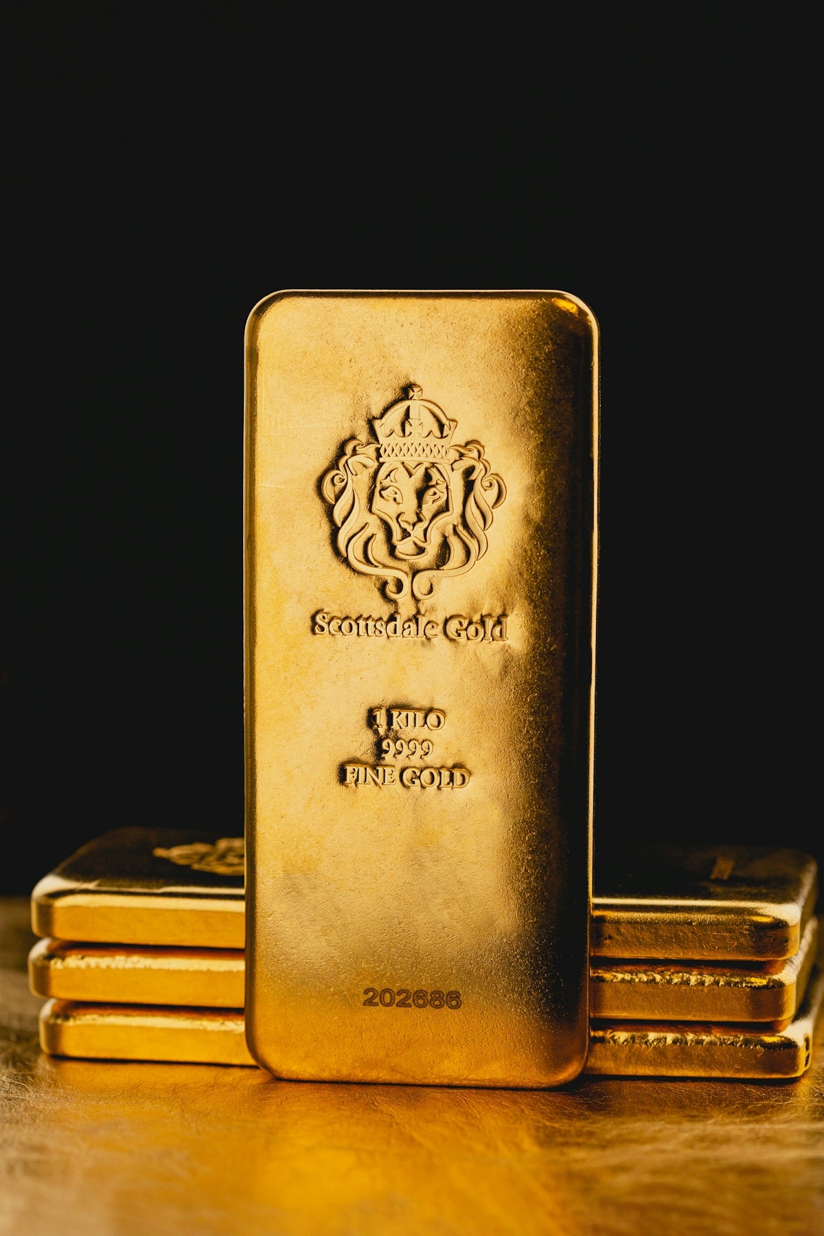 a stack of gold bars sitting on top of a wooden table