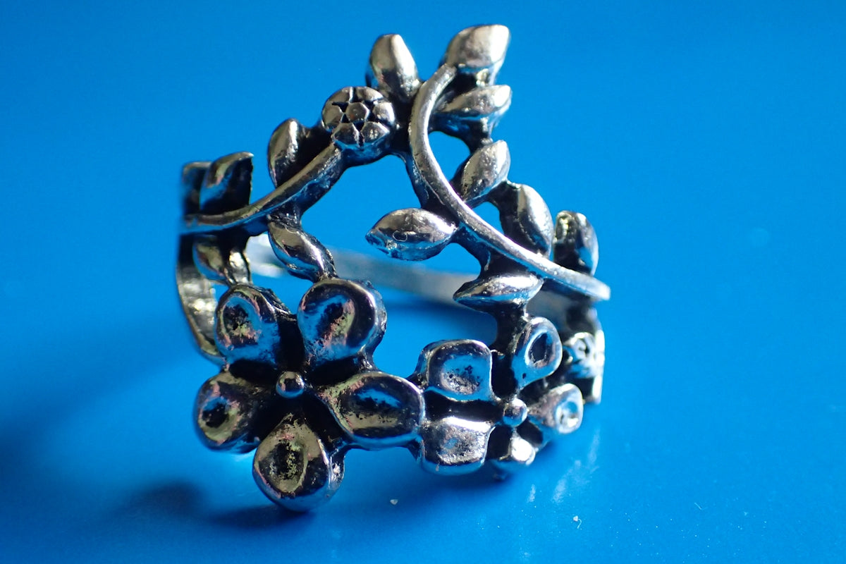 a silver ring sitting on top of a blue surface
