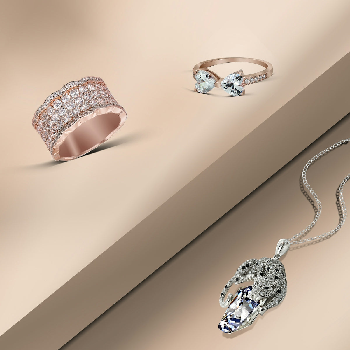 three rings and a necklace on a table