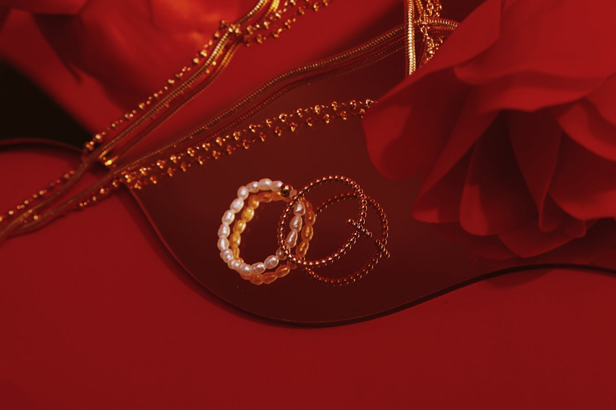 a close up of a pair of wedding rings on a red background
