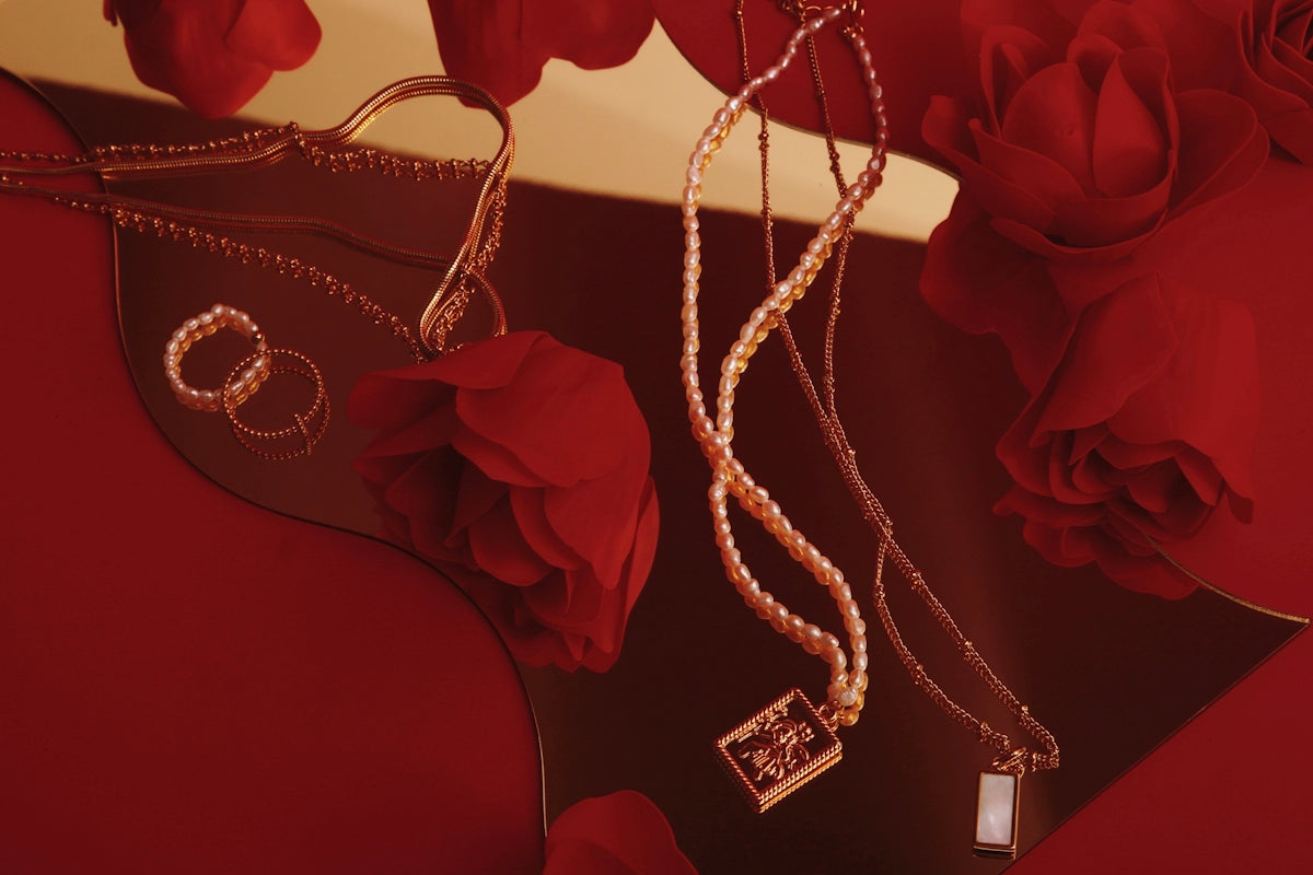 a pair of necklaces and a pair of roses