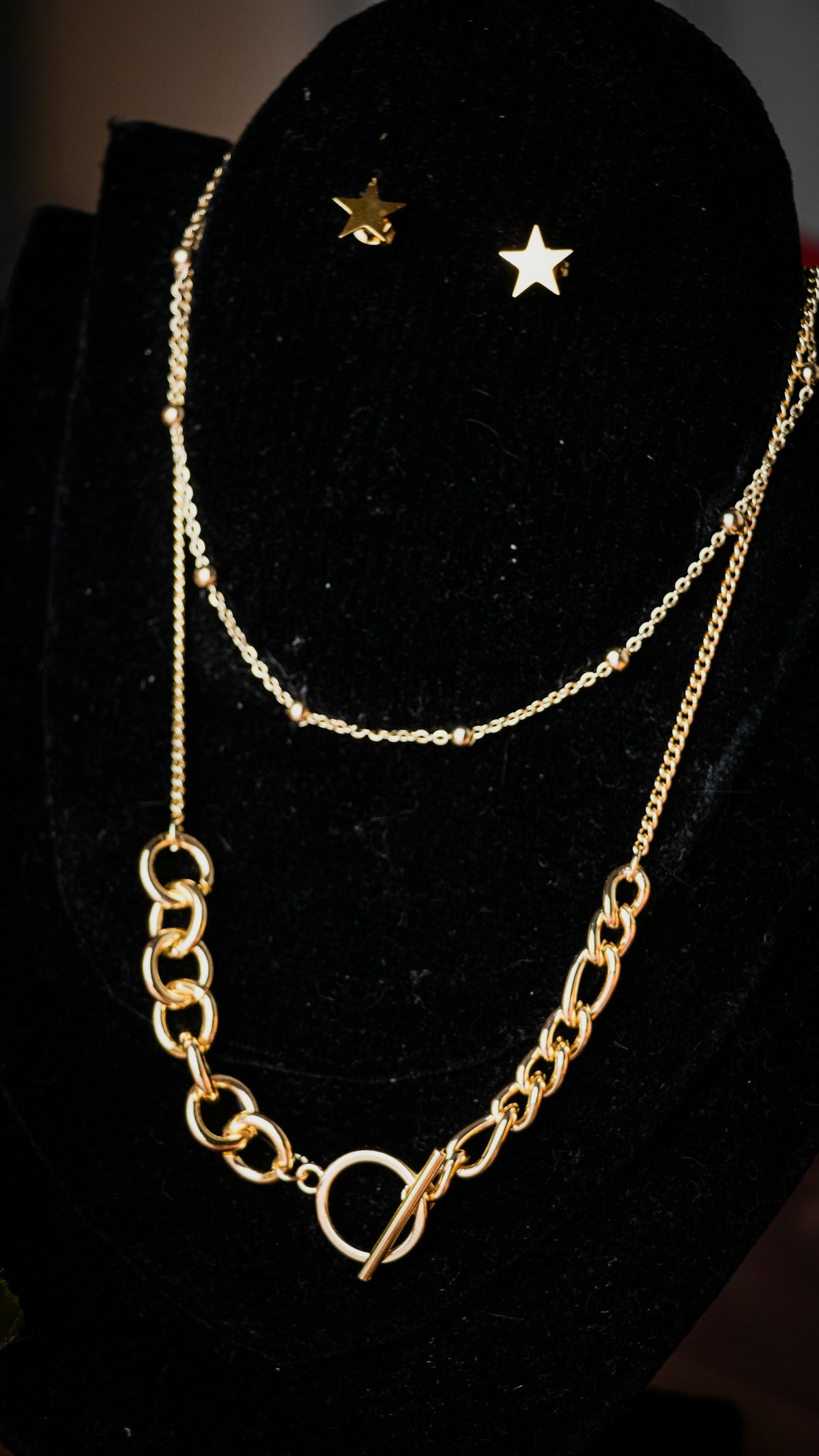 a gold necklace with a star on top of it