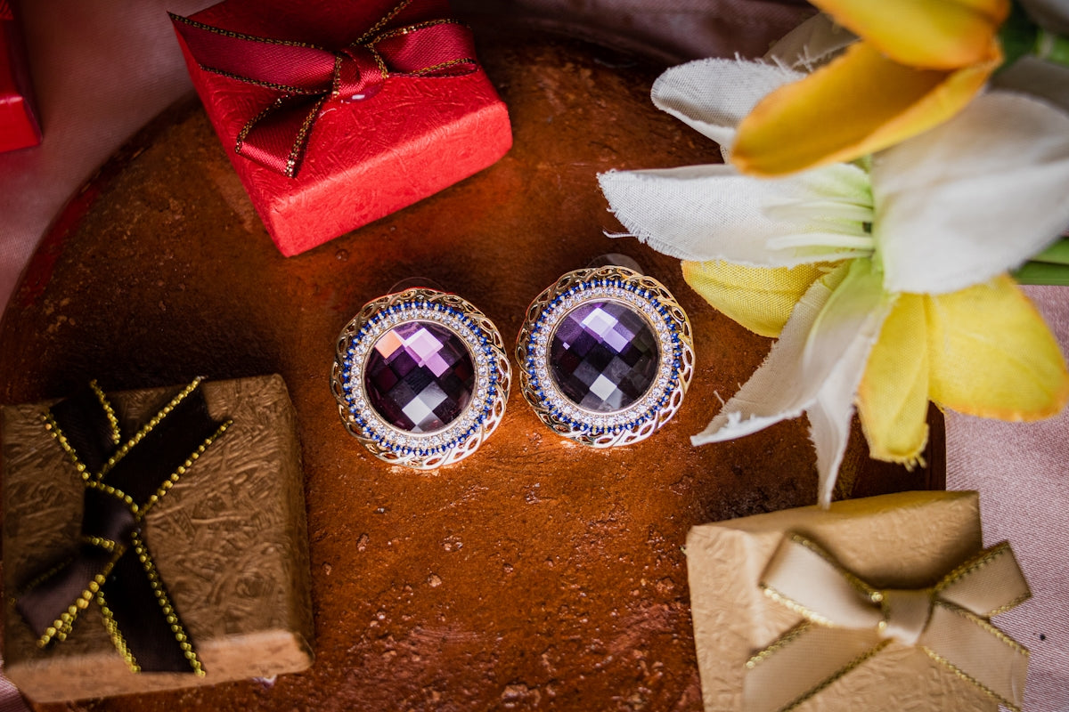 a pair of earrings sitting on top of a table
