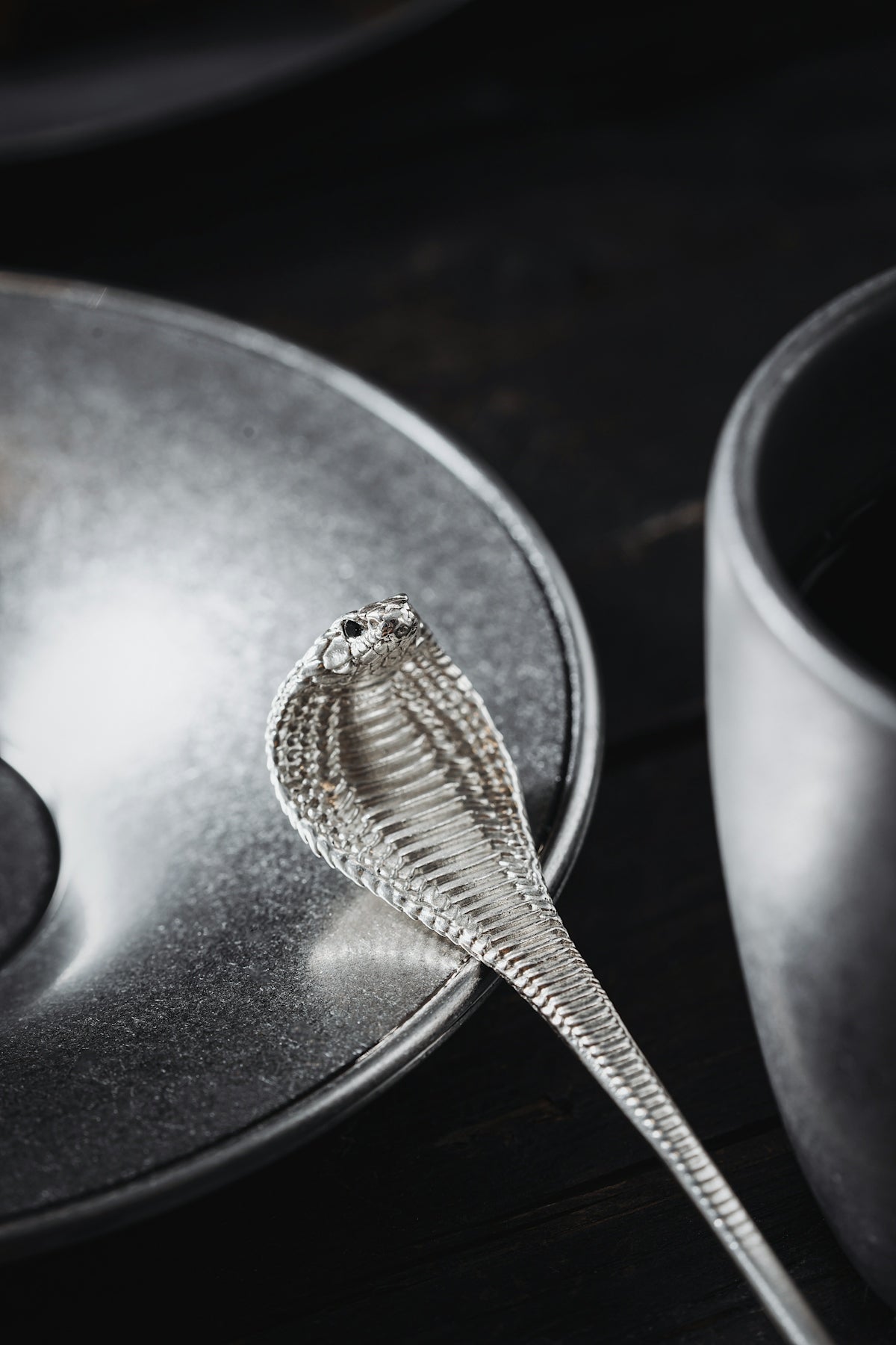 a metal spoon with a silver flower on it