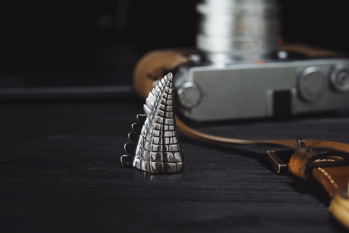 a camera and a silver object on a table
