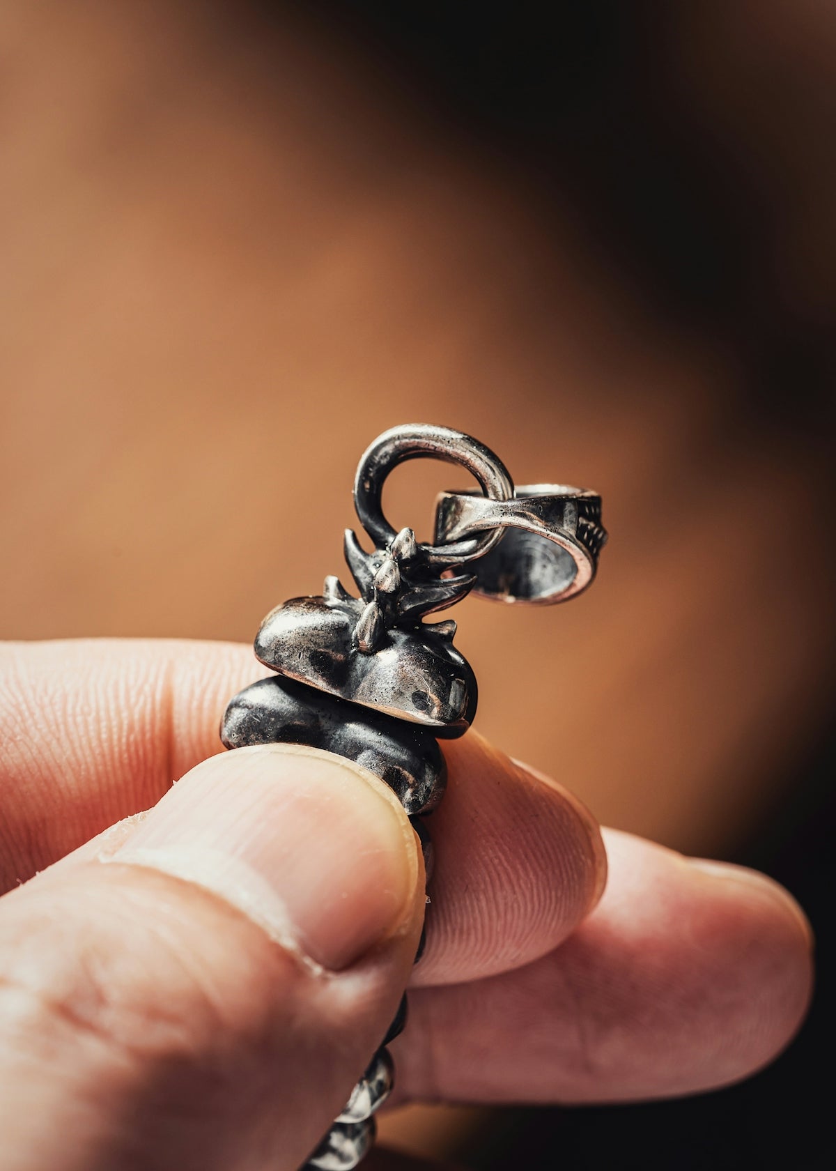 a person holding a tiny silver object in their hand