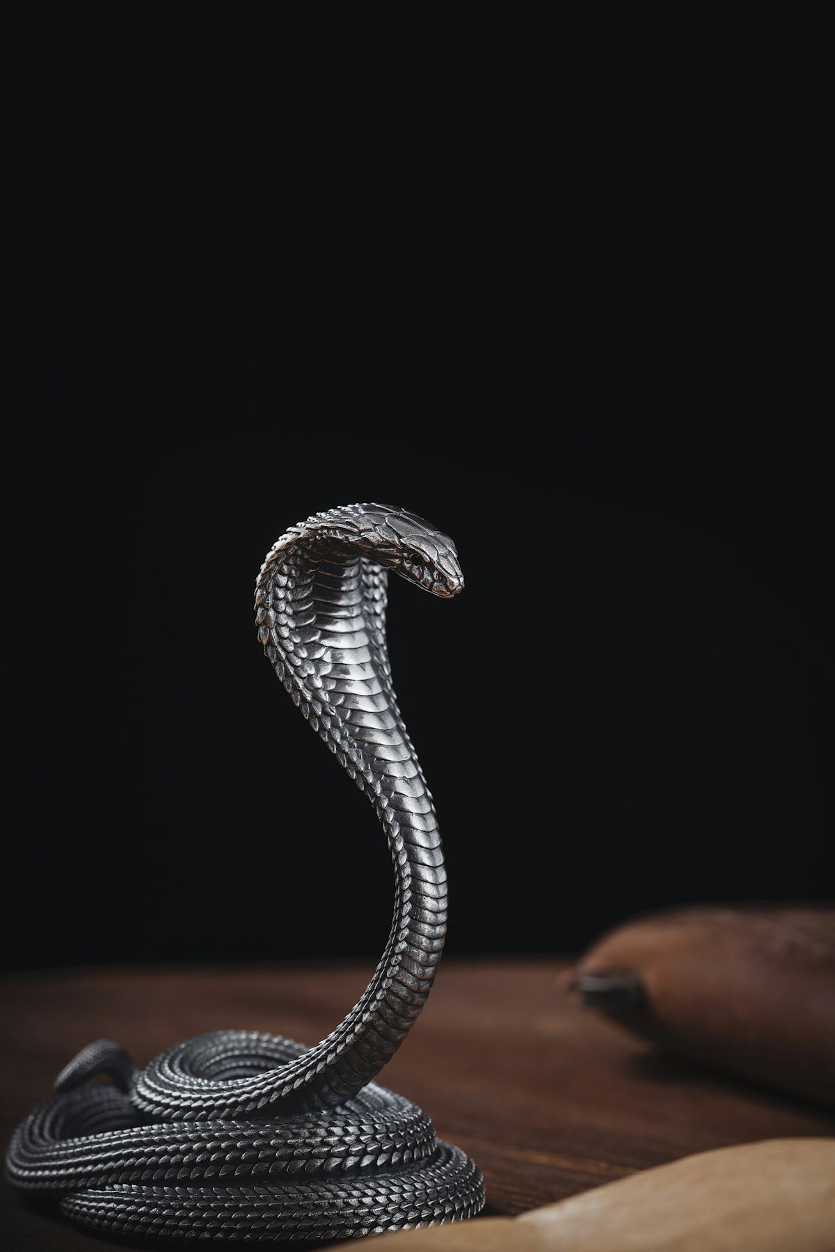 a snake statue sitting on top of a wooden table