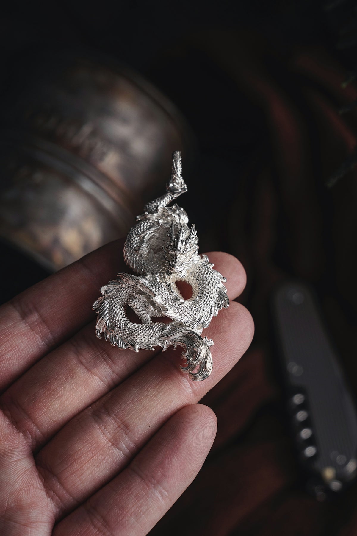 a person holding a silver object in their hand