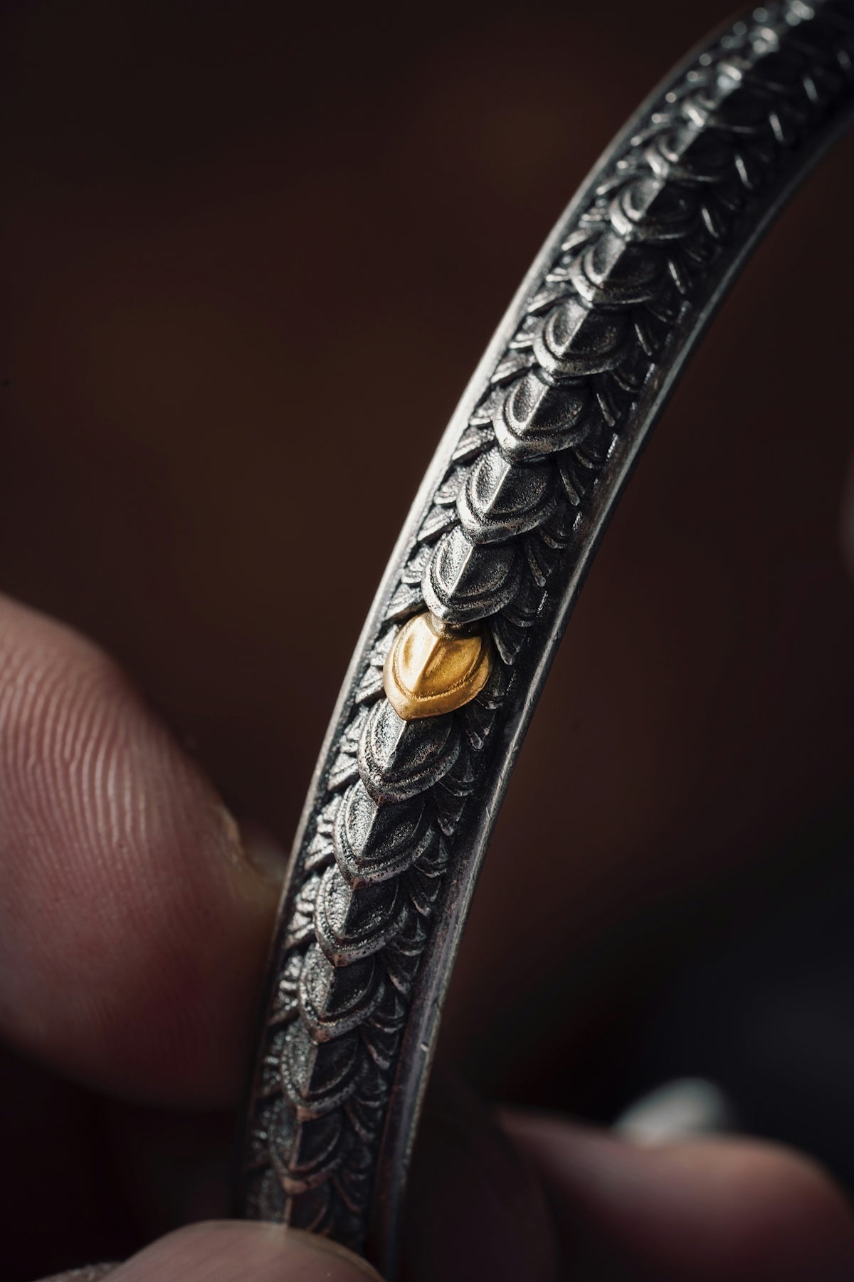 a close up of a person holding a metal object