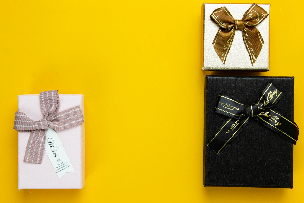 a couple of wrapped presents sitting on top of a yellow table
