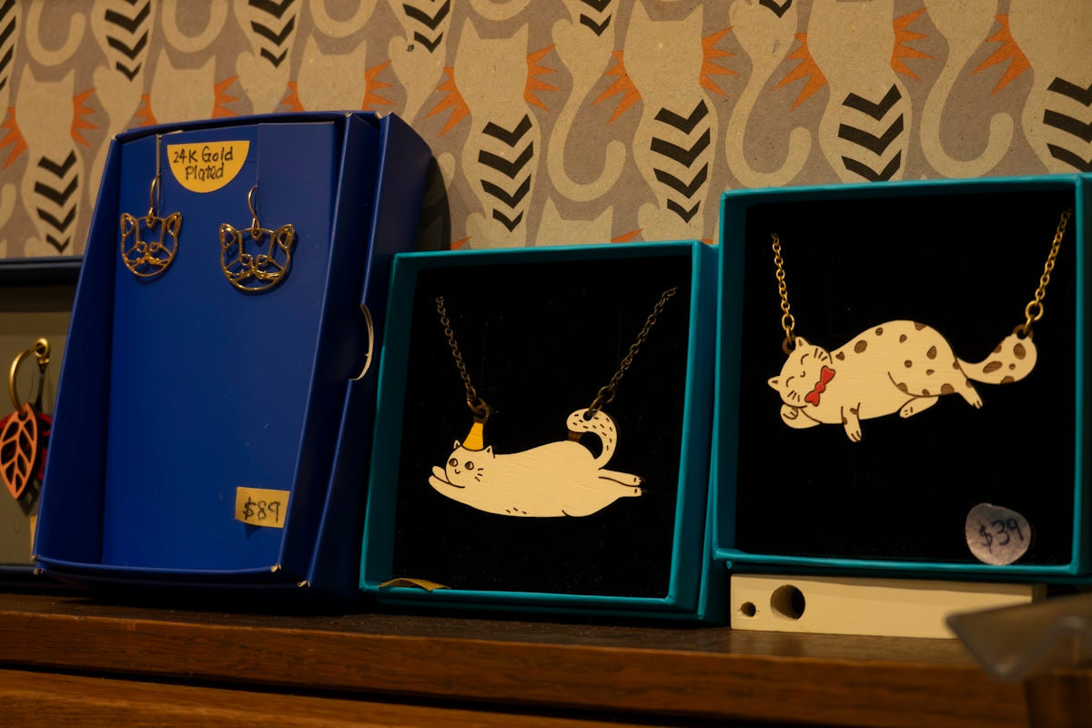 three boxes of jewelry sitting on a shelf