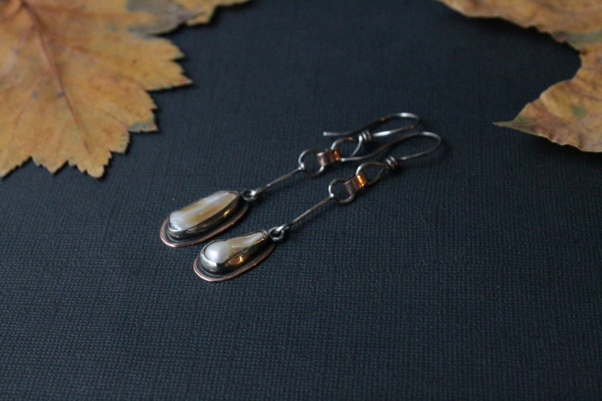 a pair of silver spoons sitting on top of a table