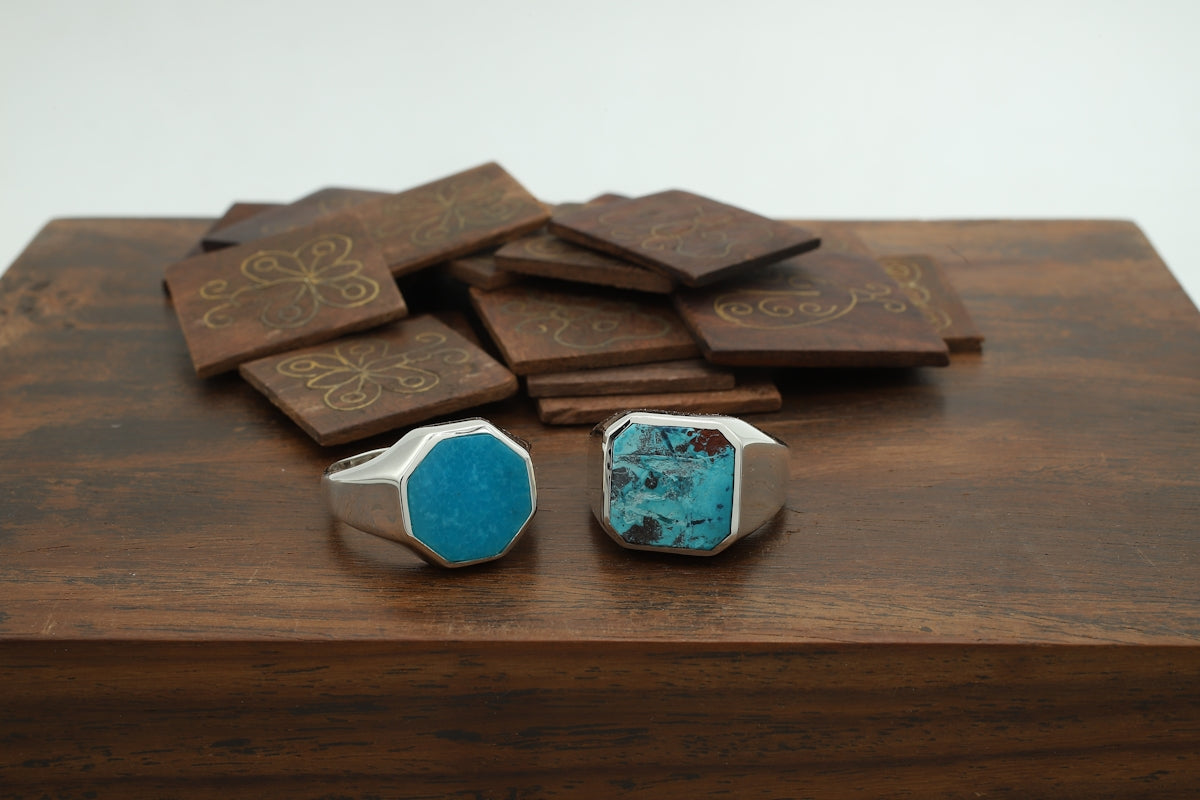 a couple of rings sitting on top of a wooden table
