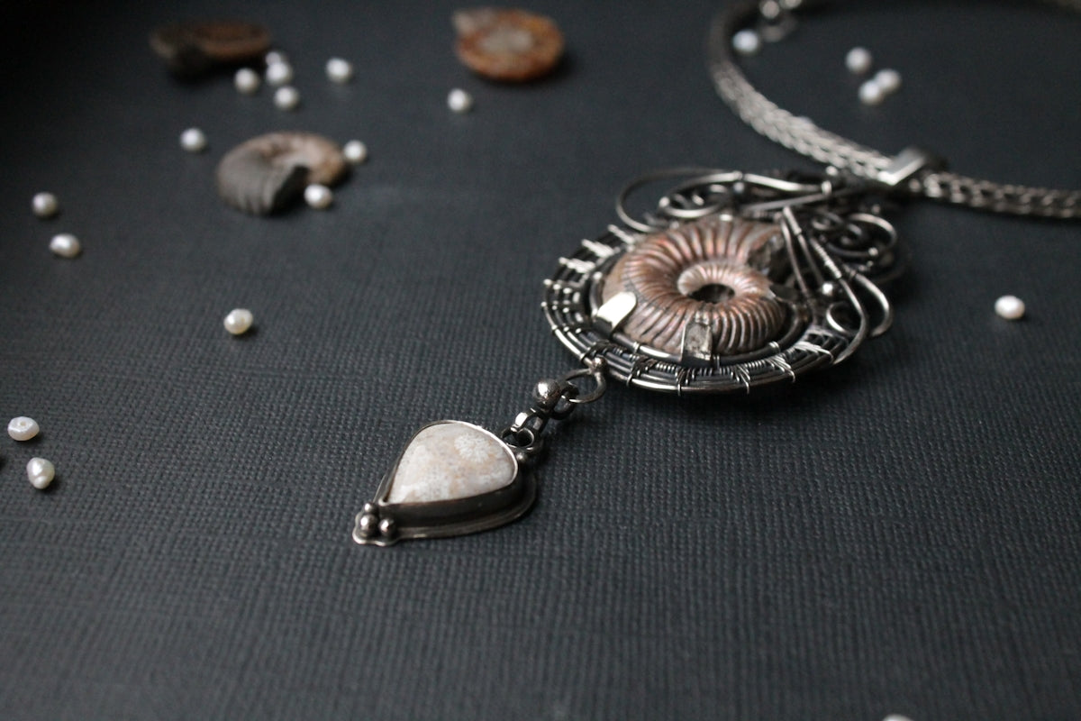 a close up of a necklace on a table