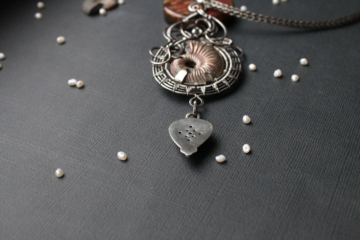 a close up of a necklace on a table