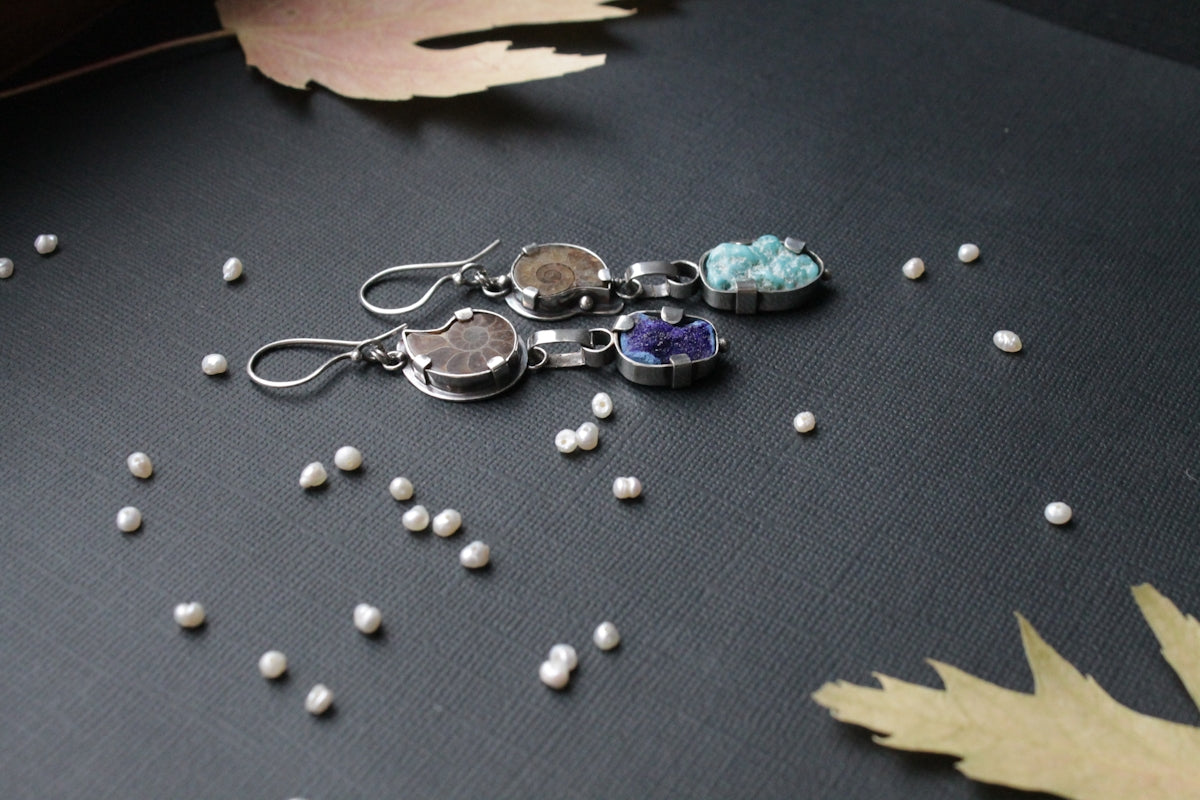 a pair of earrings sitting on top of a table