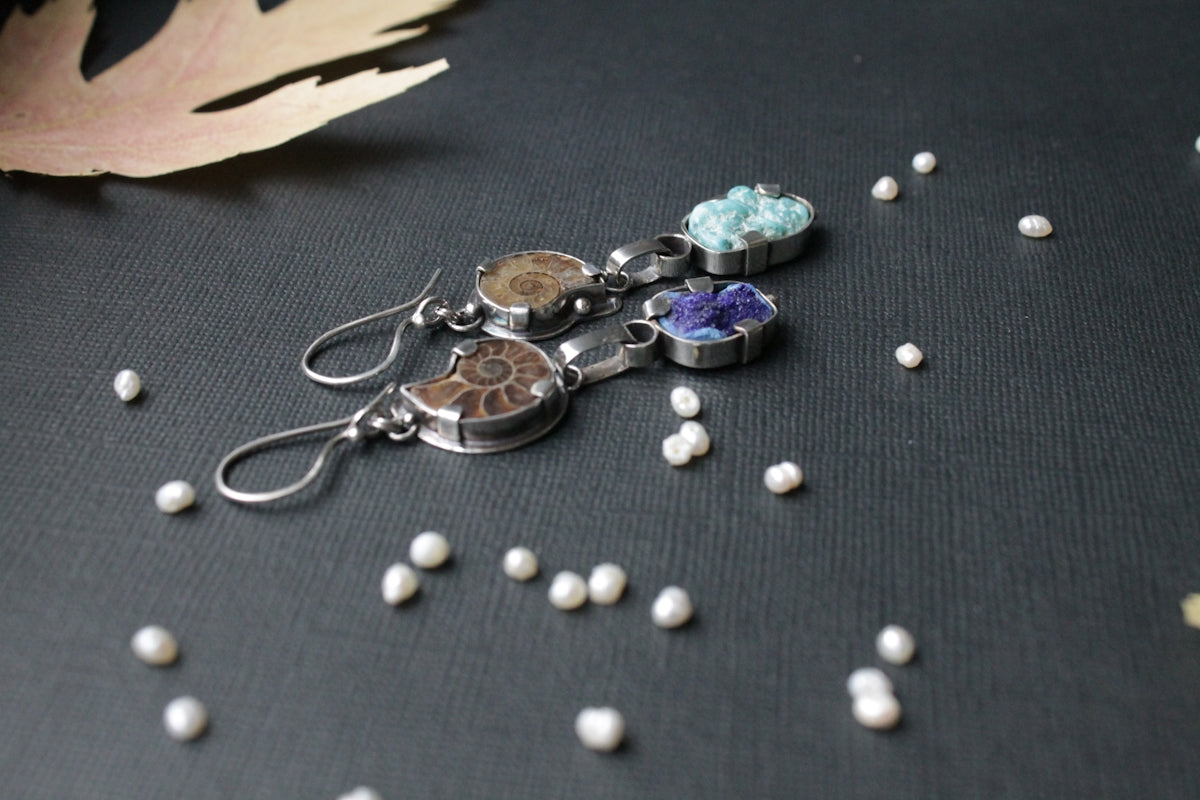 a pair of earrings sitting on top of a table