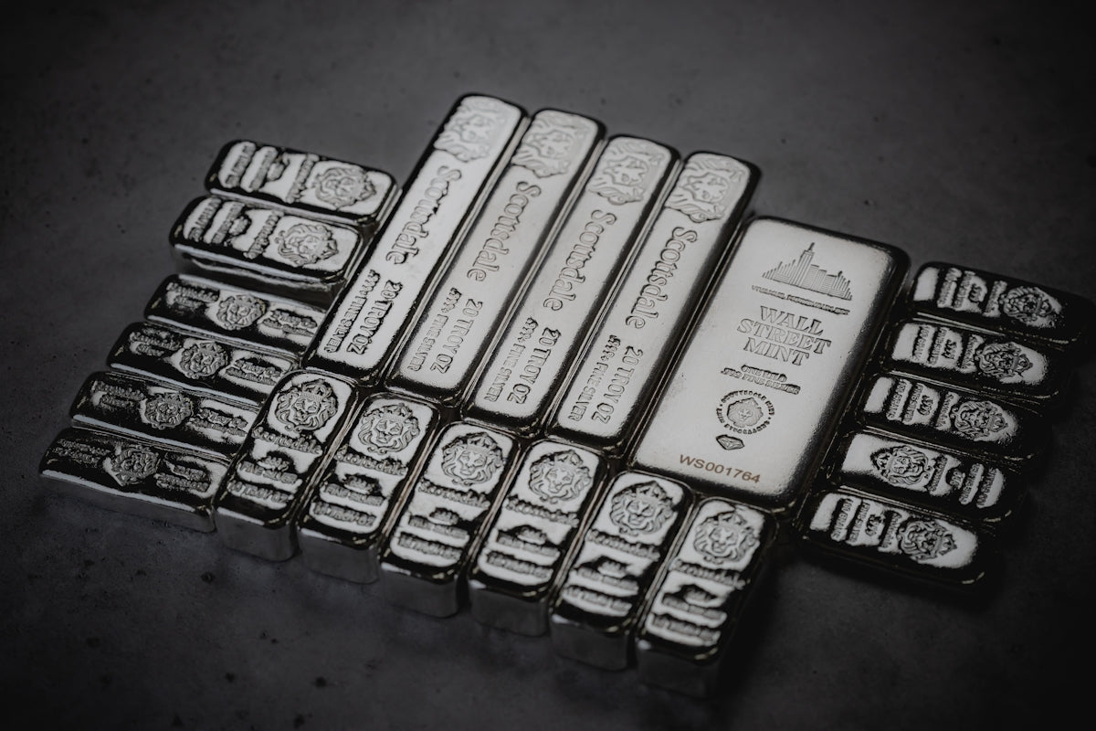 a pile of silver bars sitting on top of a table