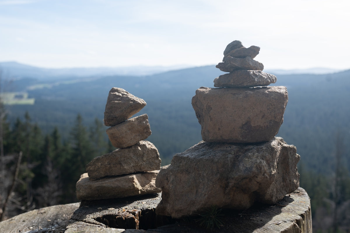 a stack of rocks sitting on top of a rock covered hillside