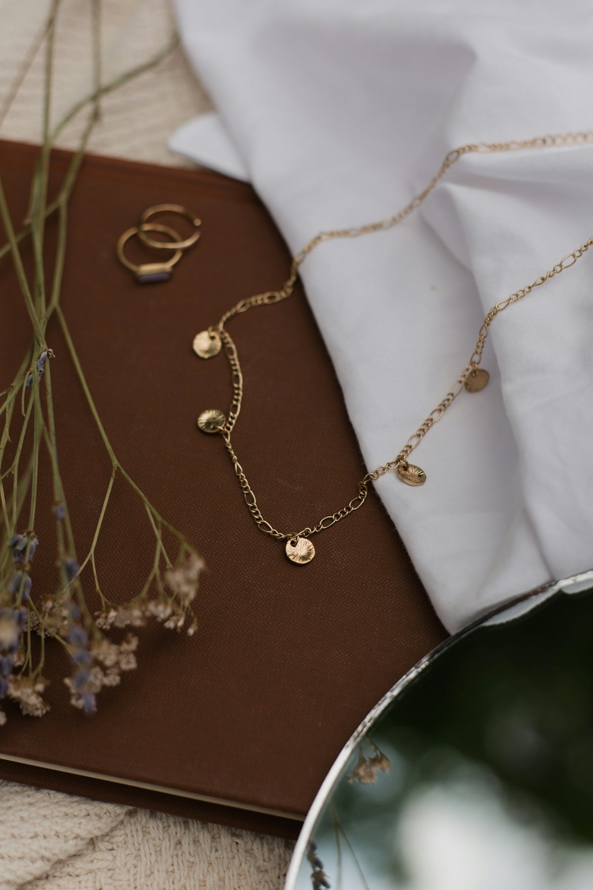 a close up of a table with flowers and jewelry