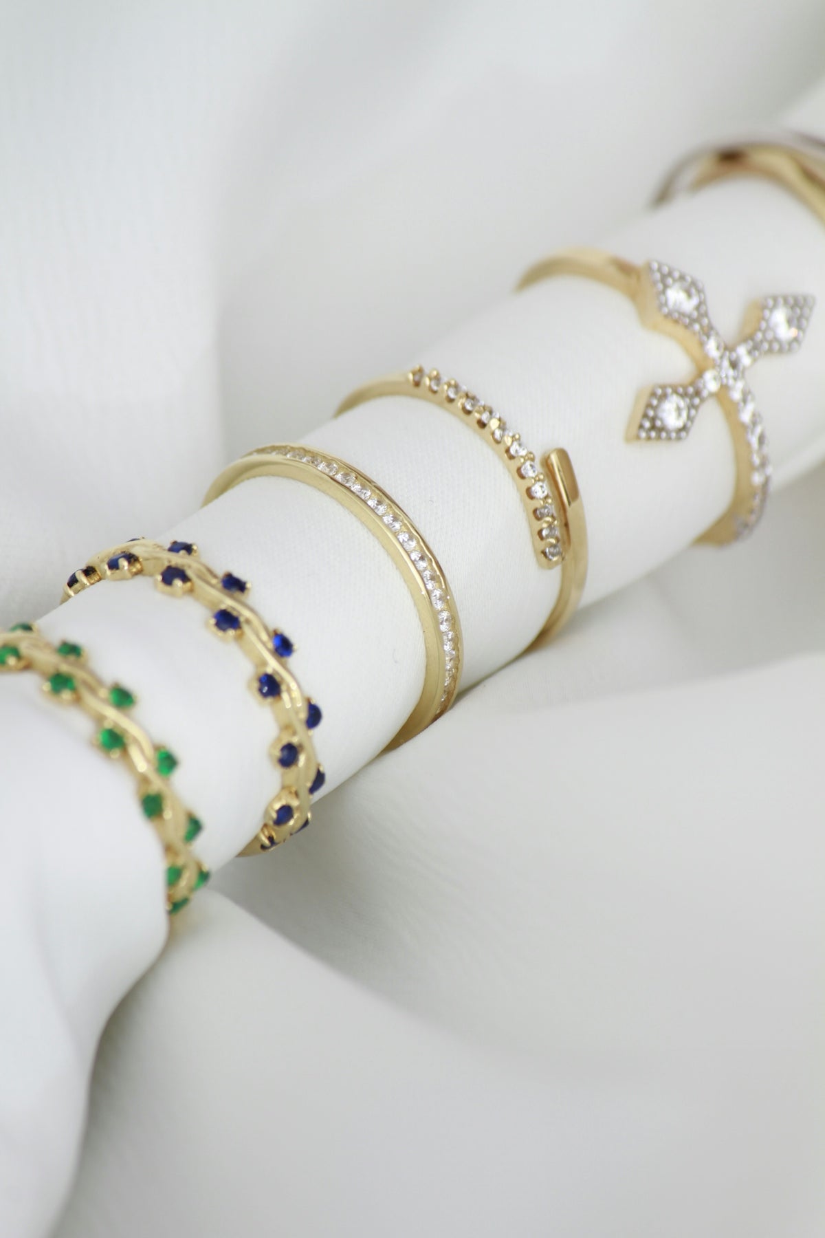 A stack of napkin rings sitting on top of a white napkin