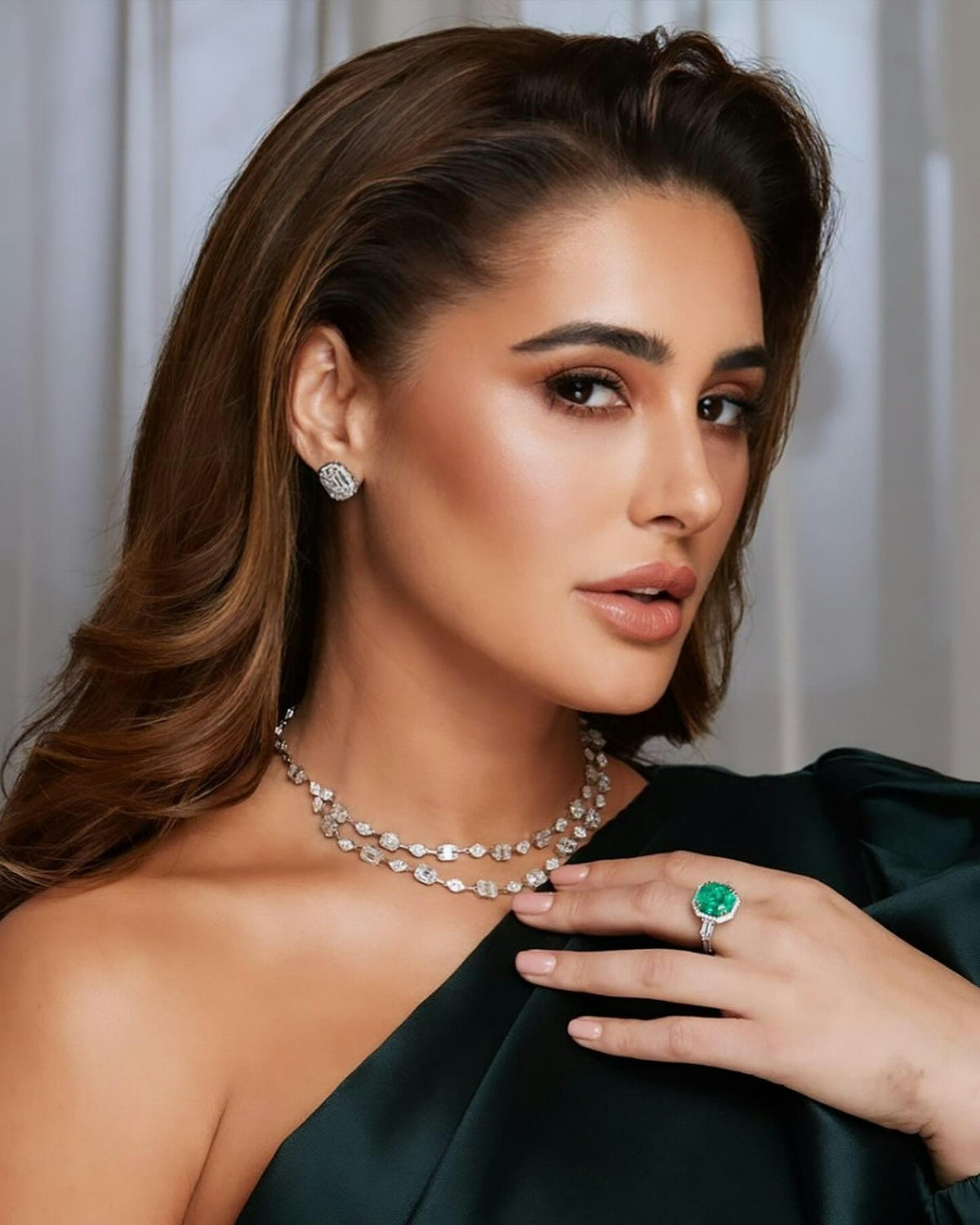 A woman wearing a green dress and a necklace