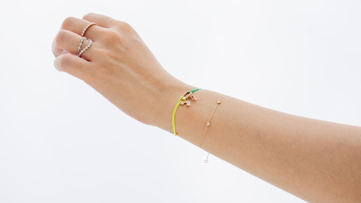 A woman's arm with a bracelet and a ring on it