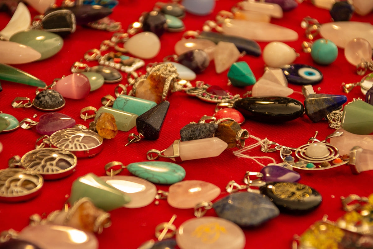 A table topped with lots of different types of necklaces