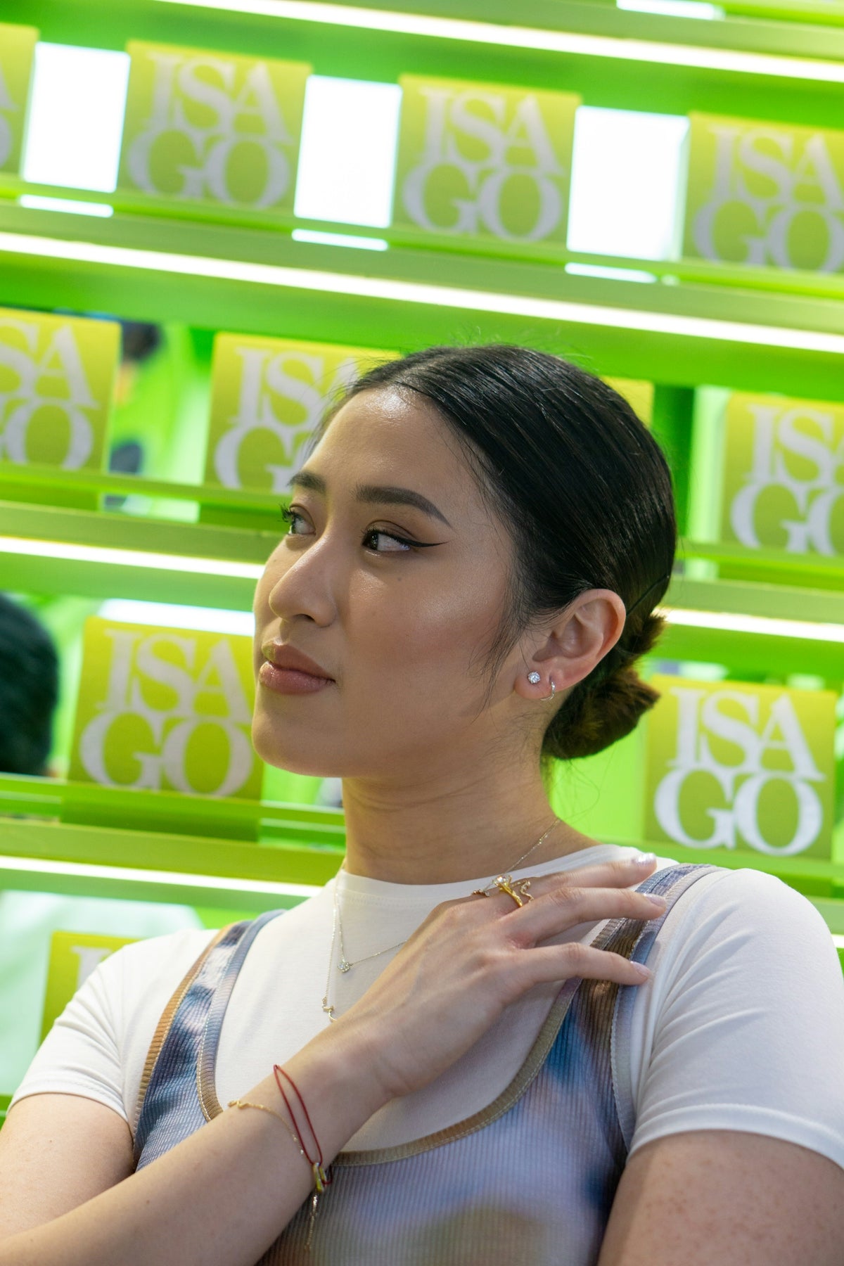 A woman standing in front of a display of jewelry
