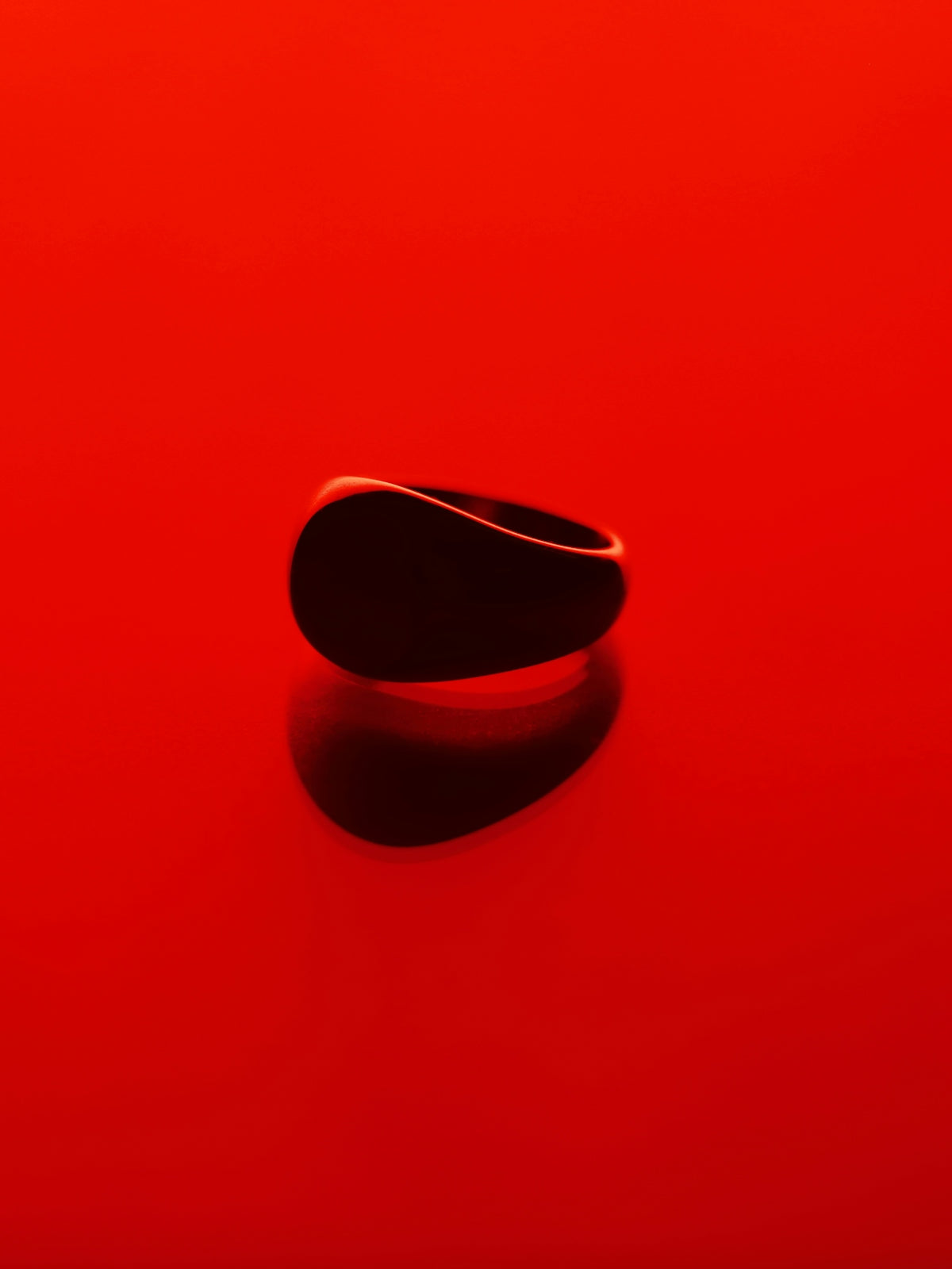 A red surface with a black object on it