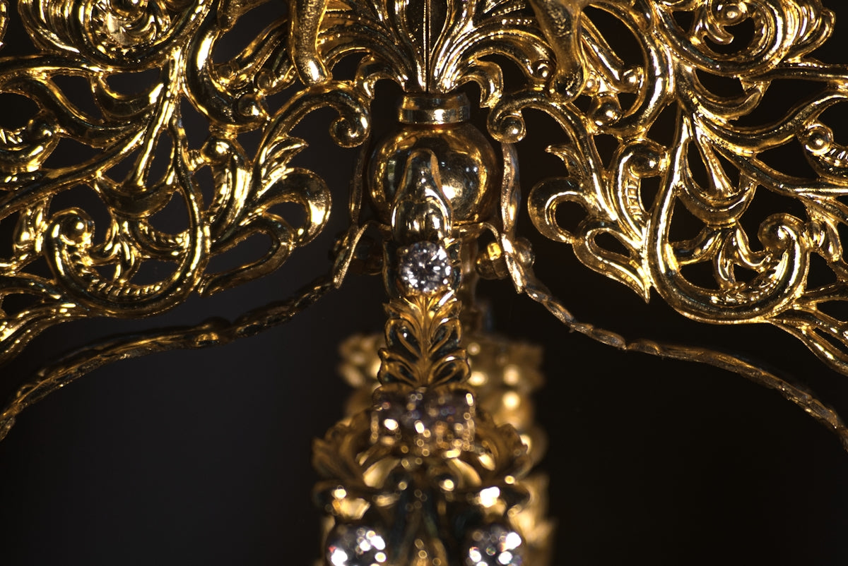 A golden chandelier with a black background