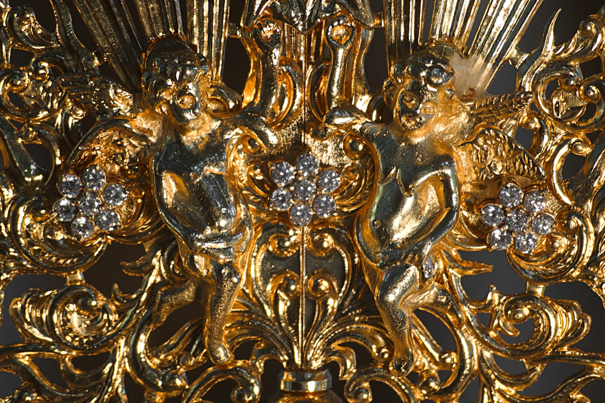 A gold chandelier with a diamond center