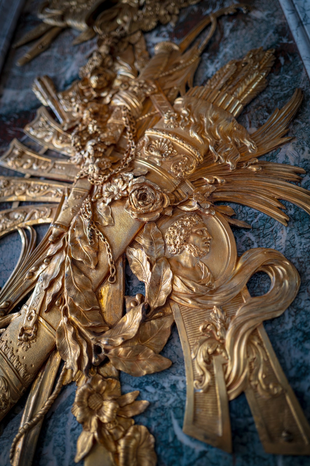 A cross with a bunch of gold crosses on it