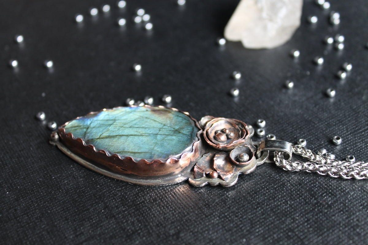 A beautiful labradorite pendant with a delicate chain.