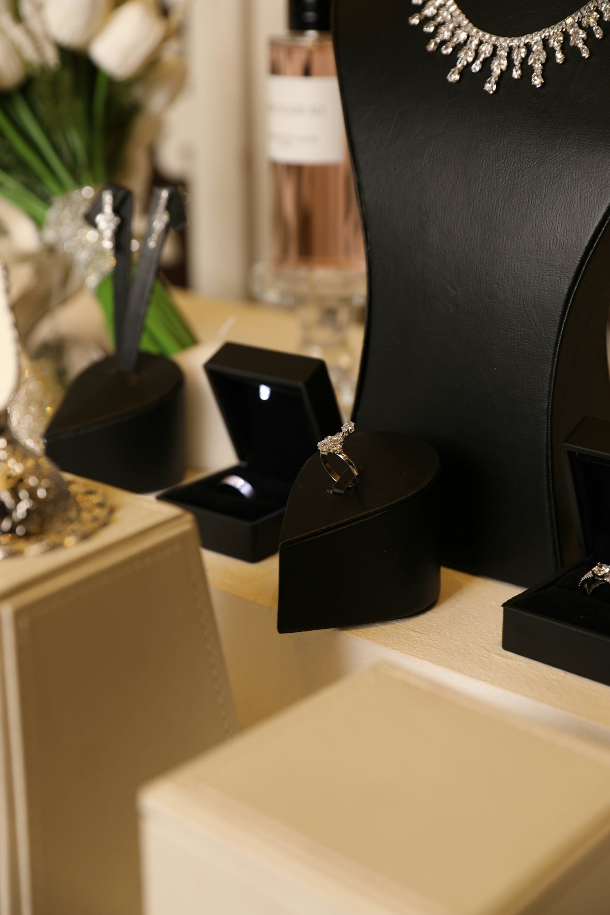 Jewelry display featuring rings and a necklace.
