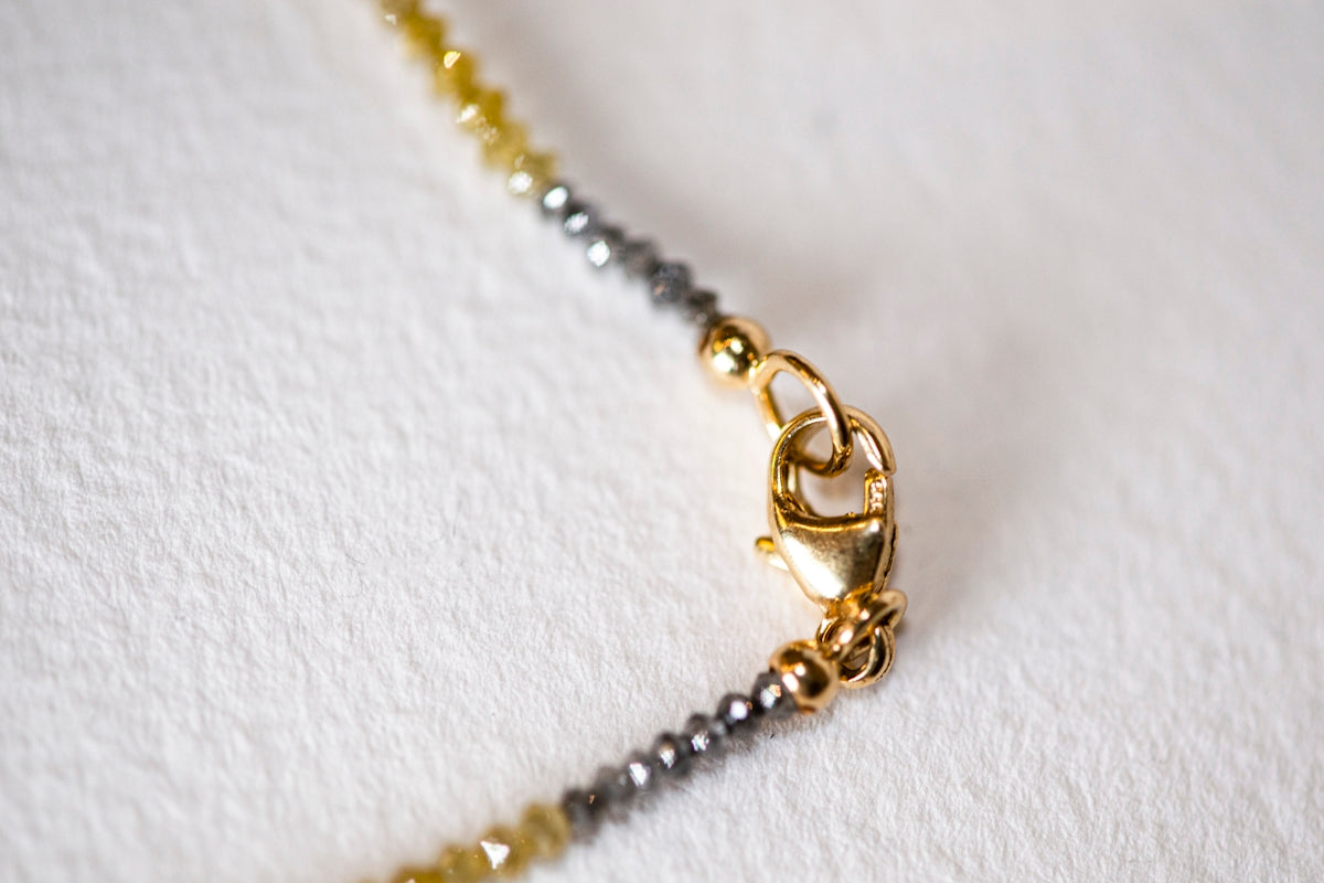 Close-up of a gold necklace clasp.