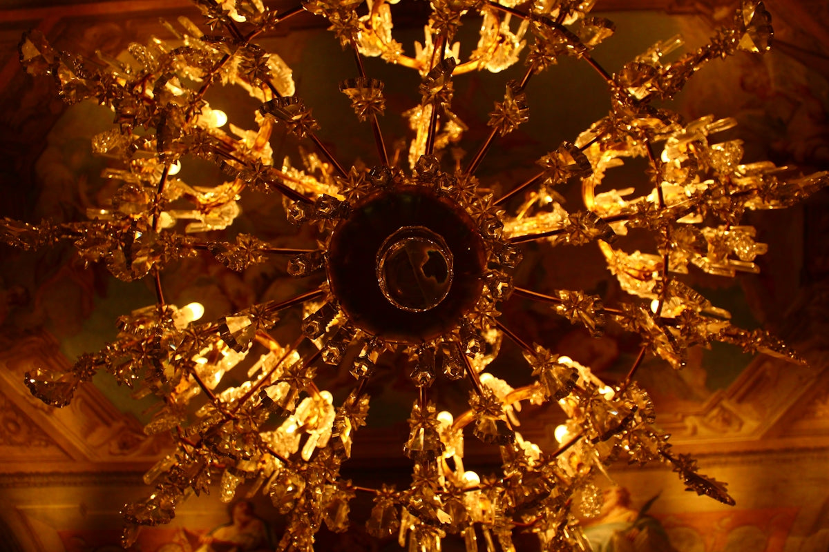 Ornate golden chandelier illuminated from below