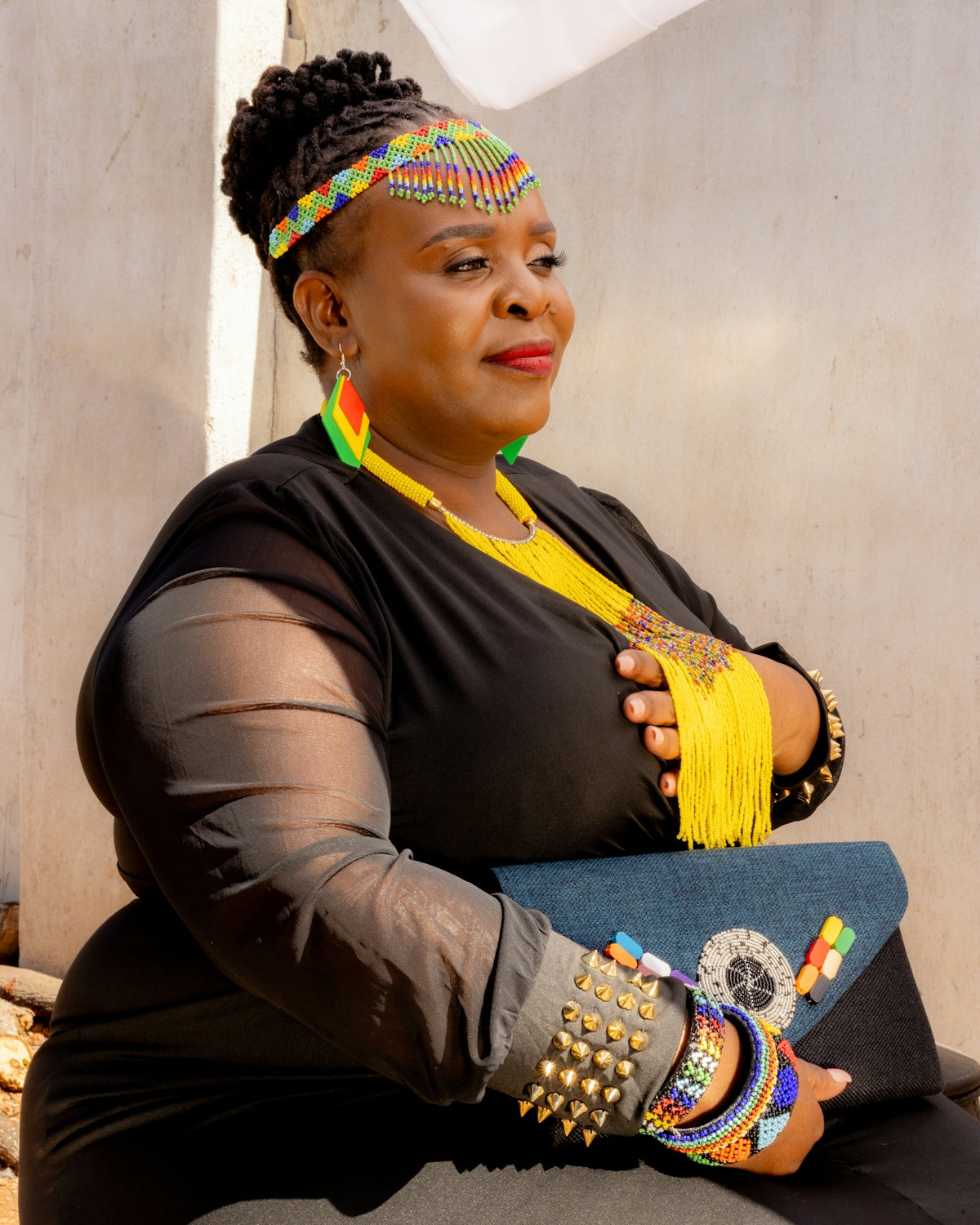 A woman in traditional beaded jewelry and attire.