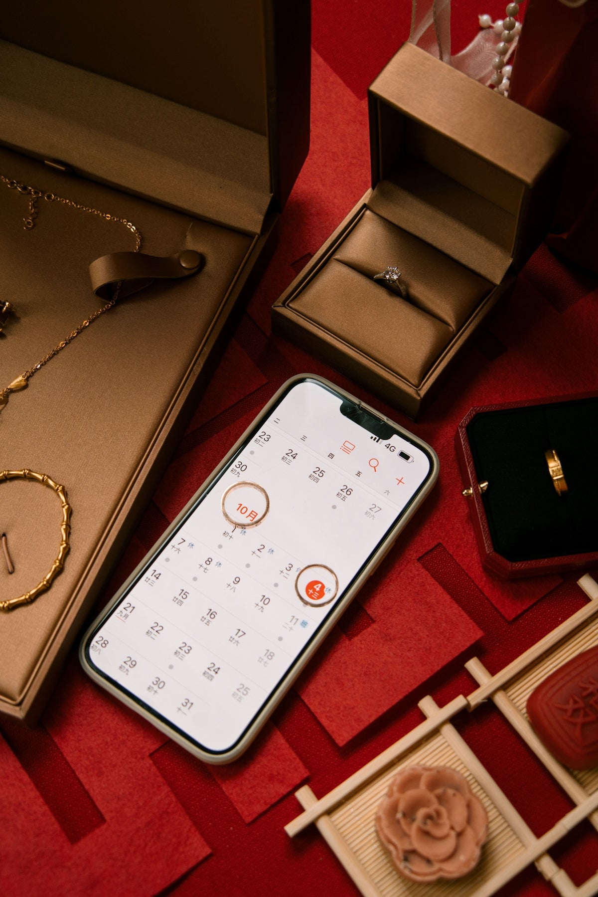 Jewelry, engagement ring, and calendar on red background