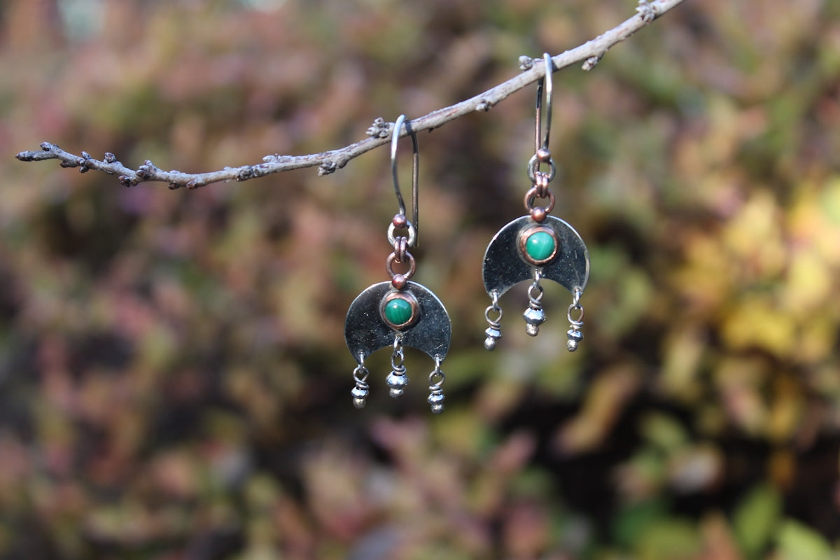 Handmade silver earrings with green stones hanging