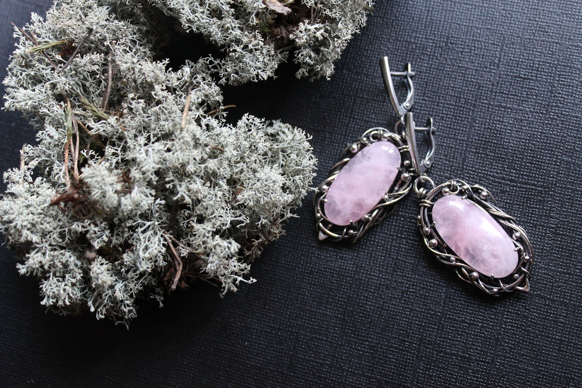Silver earrings with pink stones and dried moss