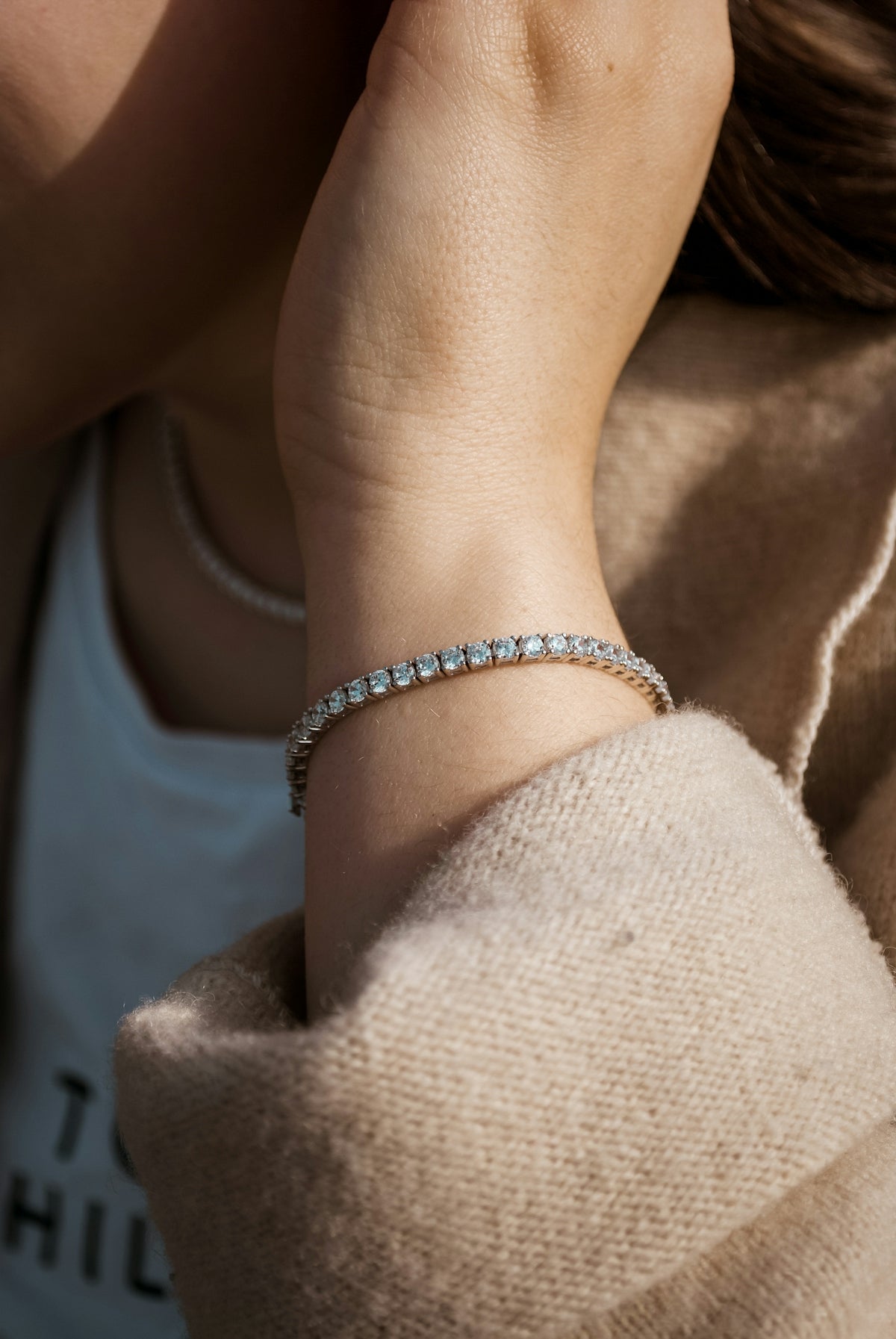A diamond bracelet on a woman's wrist.