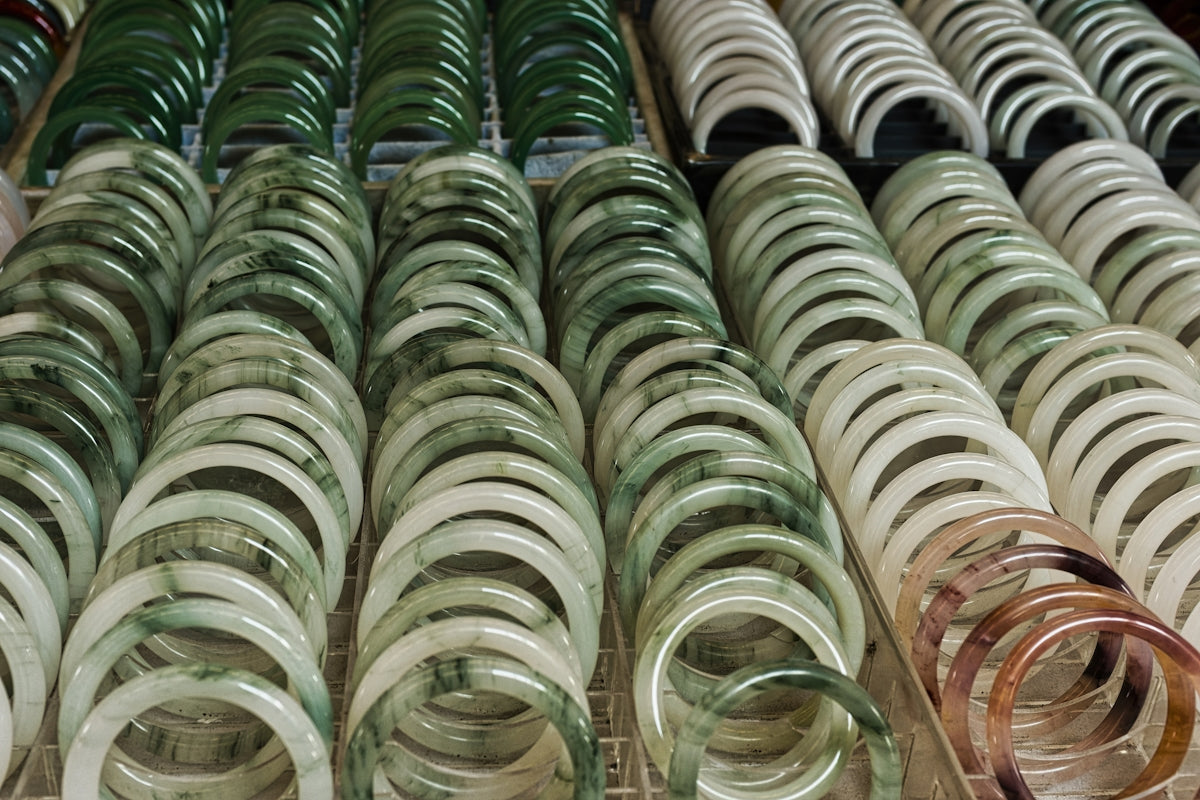 Rows of jade bracelets in various green and white shades