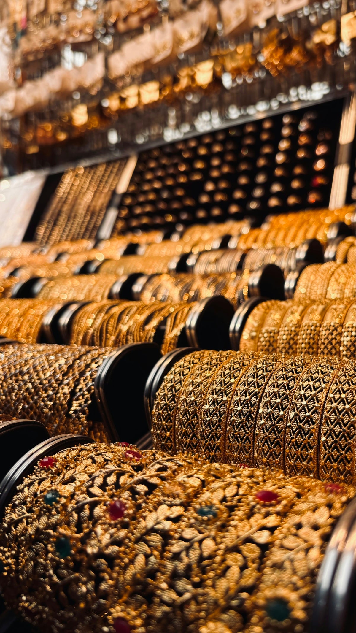 Rows of ornate gold bangles with intricate designs