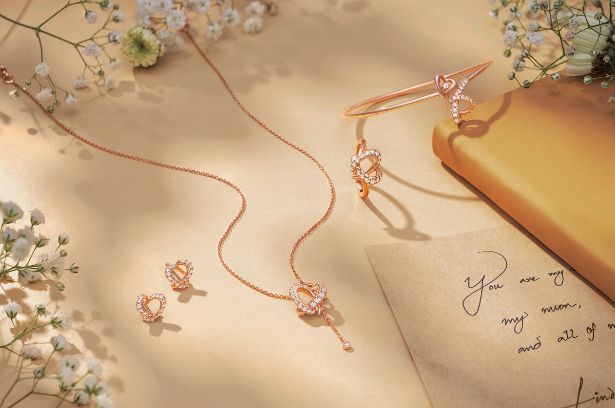 Rose gold jewelry set with flowers and letter
